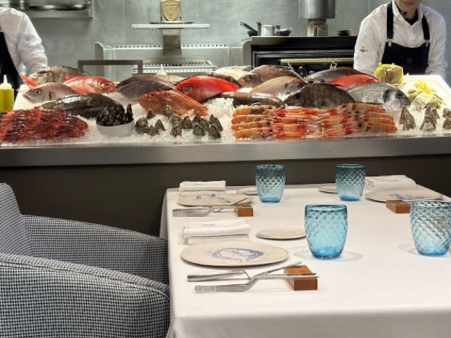 Estimar fish counter on ice beside a set table