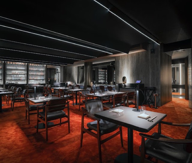 Kabuki dining room with red carpet and dark walls