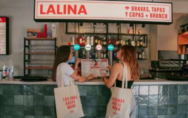La Lina bar counter with the Bravas, tapas y copas + brunch sign