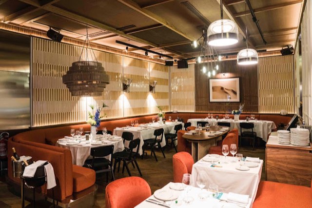 Lobito de Mar dining room with orange banquettes