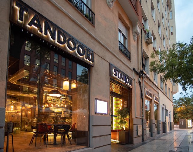 Tandoori Station facade with lit signage at dusk