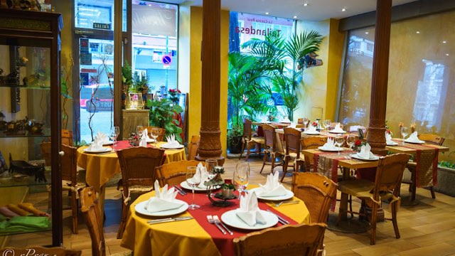 Thaidy dining room with yellow tablecloths and palms